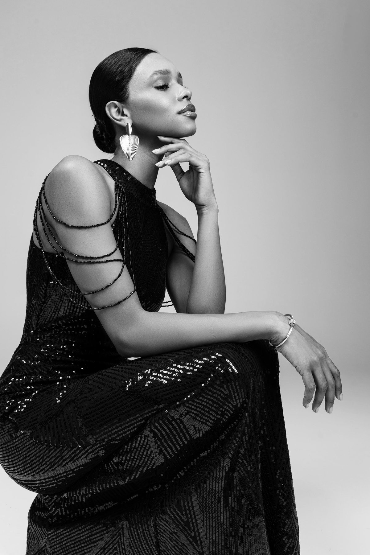 Sequin gown seated portrait, black and white editorial
